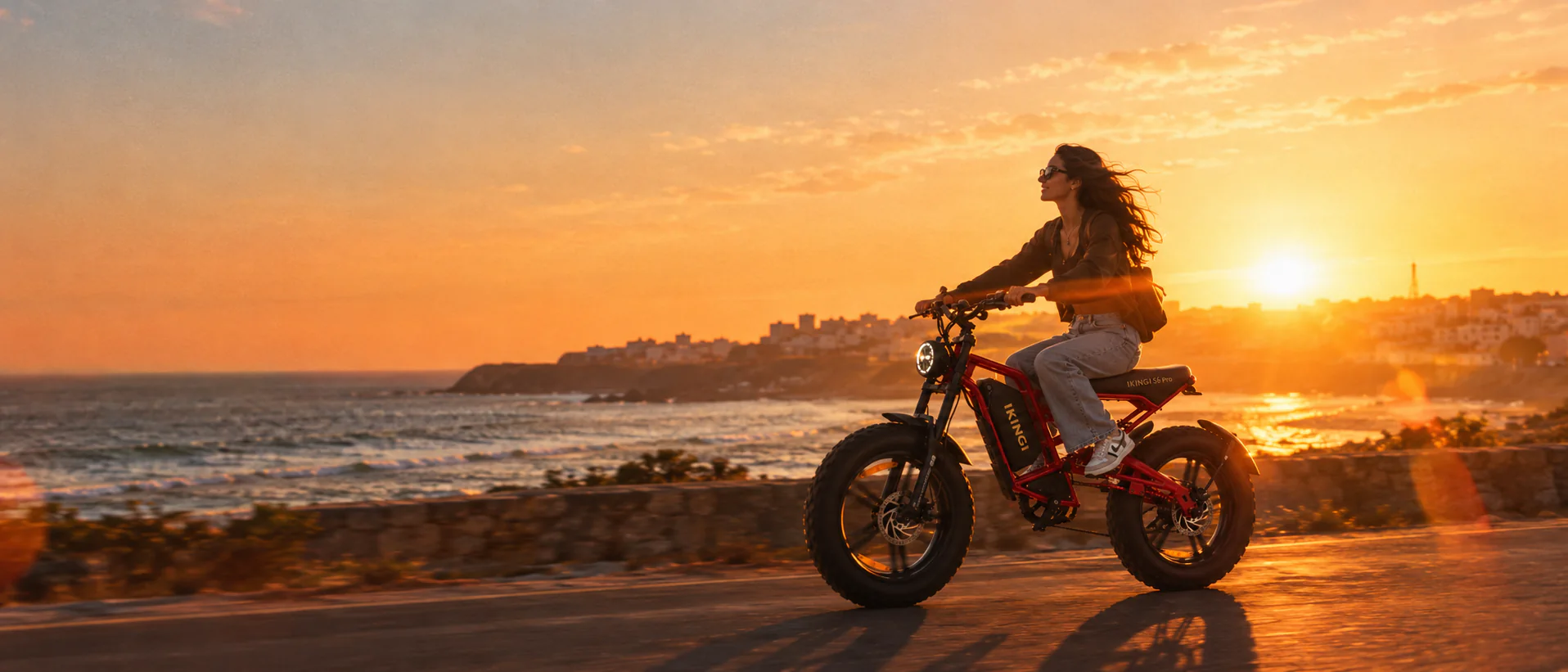 Rider on a red IKINGI e-bike above the Imsouane coast at sunset