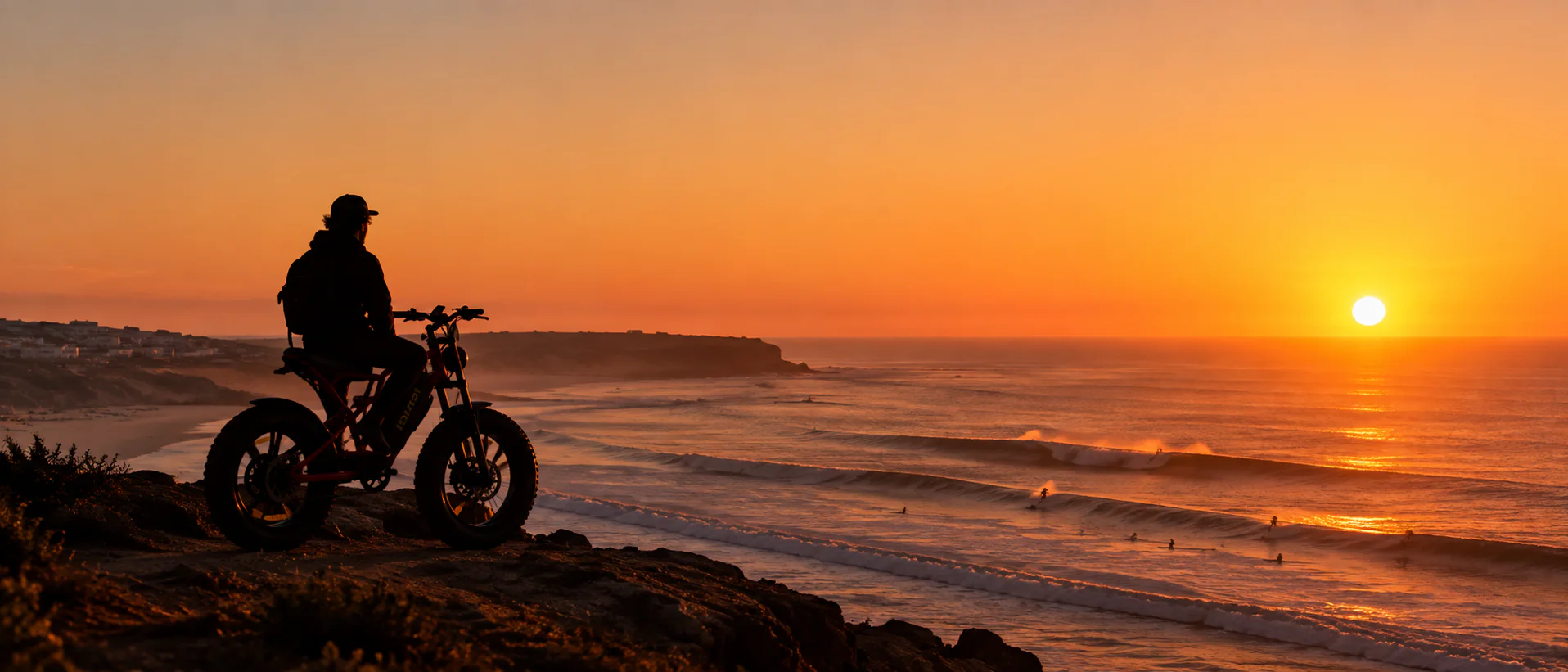 E-bike rider overlooking the Imsouane surf at sunset